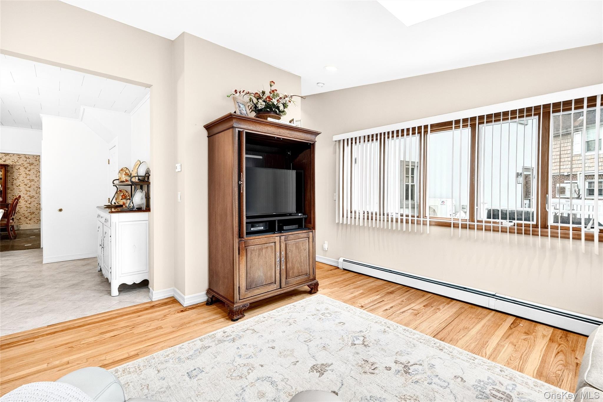 3334 Country Club Road Bronx, NY 10465 - Photo 23 of 49 Living area with baseboard heating, healthy amount of natural light, and light wood-type flooring