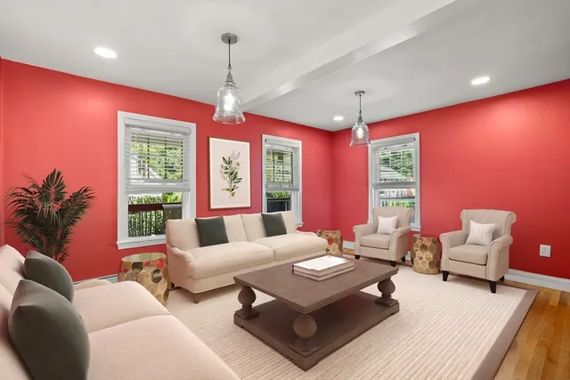 a living room with furniture a chandelier and a large window