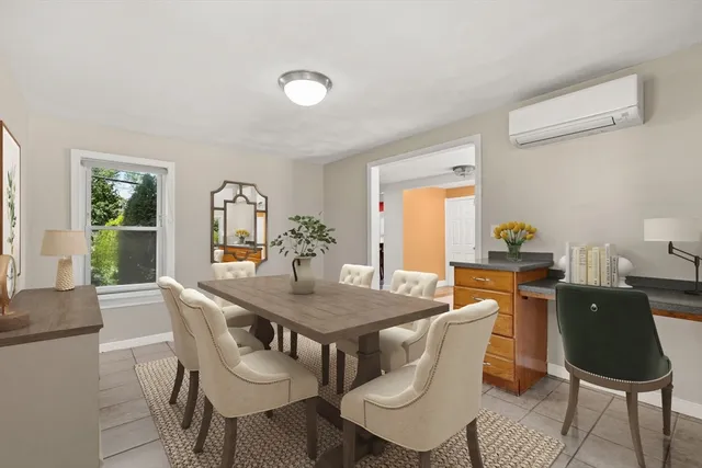 a dining room with furniture and window