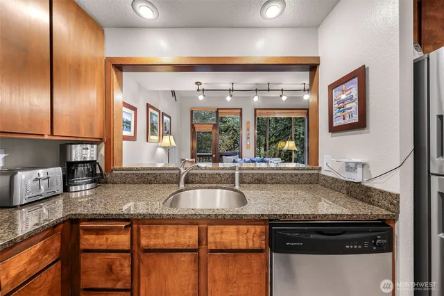 a kitchen with granite countertop a sink and a window