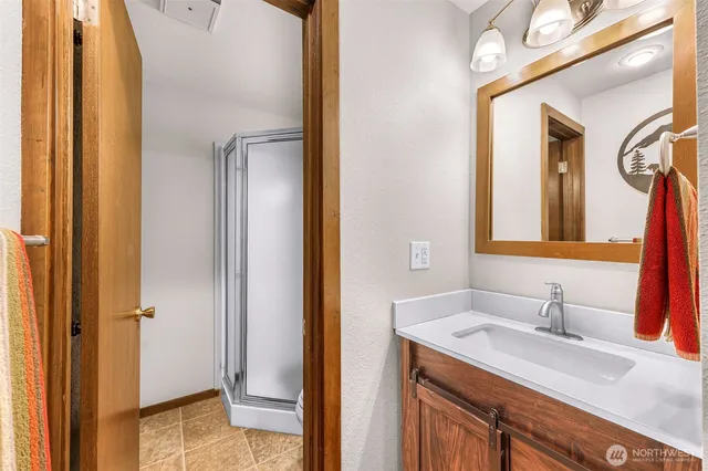 a bathroom with a granite countertop sink and a mirror