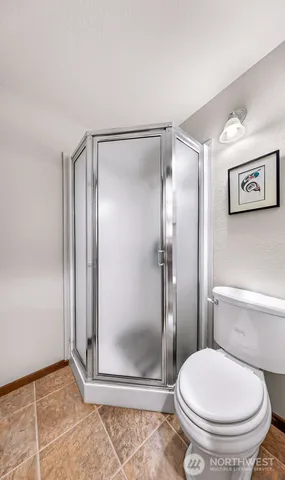 a bathroom with a glass shower door