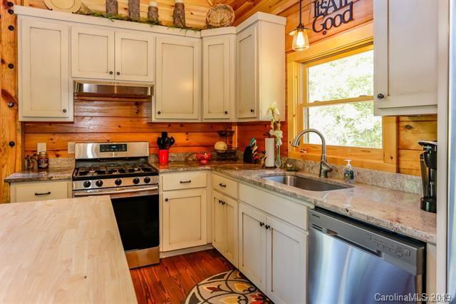 91 Zachary Lane Rutherfordton, NC 28139 - Photo 13 of 37 a kitchen with granite countertop stainless steel appliances a sink window and cabinets