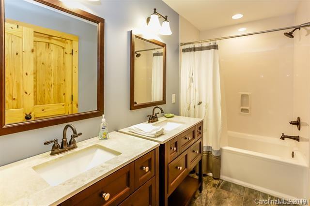 91 Zachary Lane Rutherfordton, NC 28139 - Photo 24 of 37 a bathroom with a granite countertop sink mirror and a bathtub