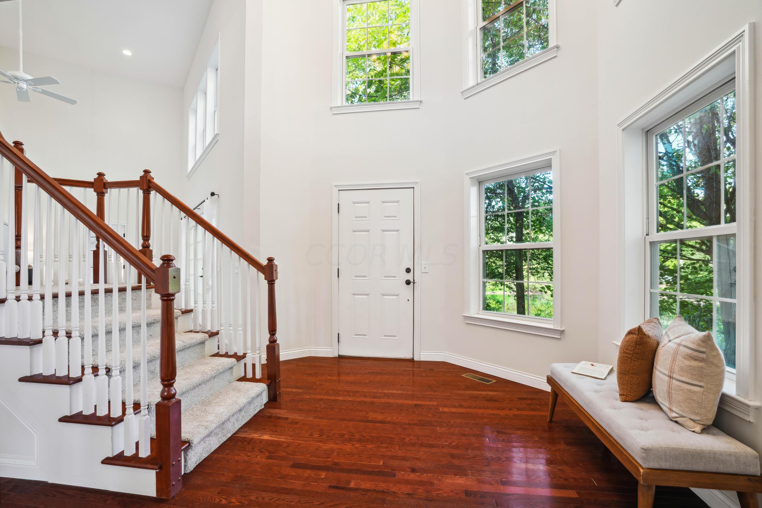 10403 Liberty Road Powell, OH 43065 - Photo 2 of 76 Grand entry way with hardwood floors, views of the pond and a open staircase!
