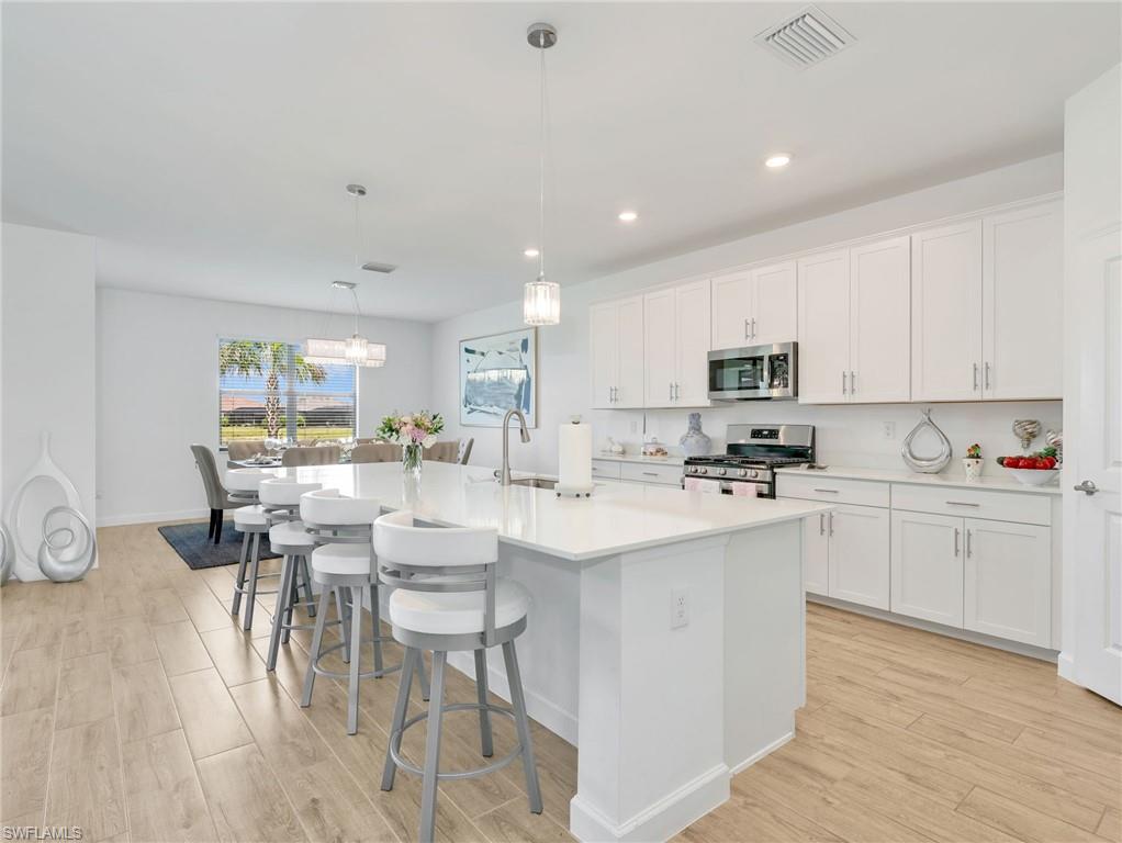 18278 Ridgeline Drive Estero, FL 33928 - Photo 6 of 45 a kitchen with appliances a sink and cabinets