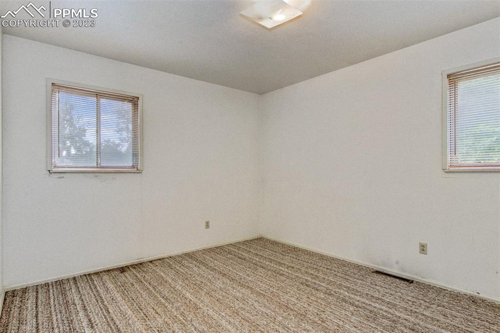 5380 Babcock Court Colorado Springs, CO 80915 - Photo 12 of 28 a view of empty room with wooden floor and fan