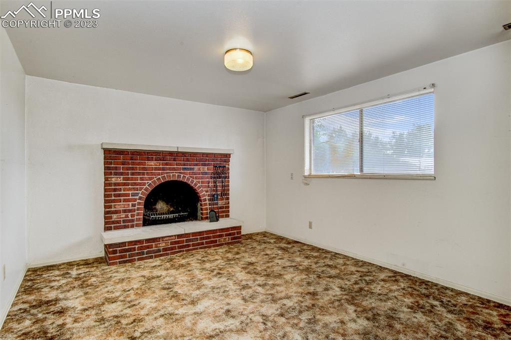 5380 Babcock Court Colorado Springs, CO 80915 - Photo 14 of 28 a view of empty room with a fireplace