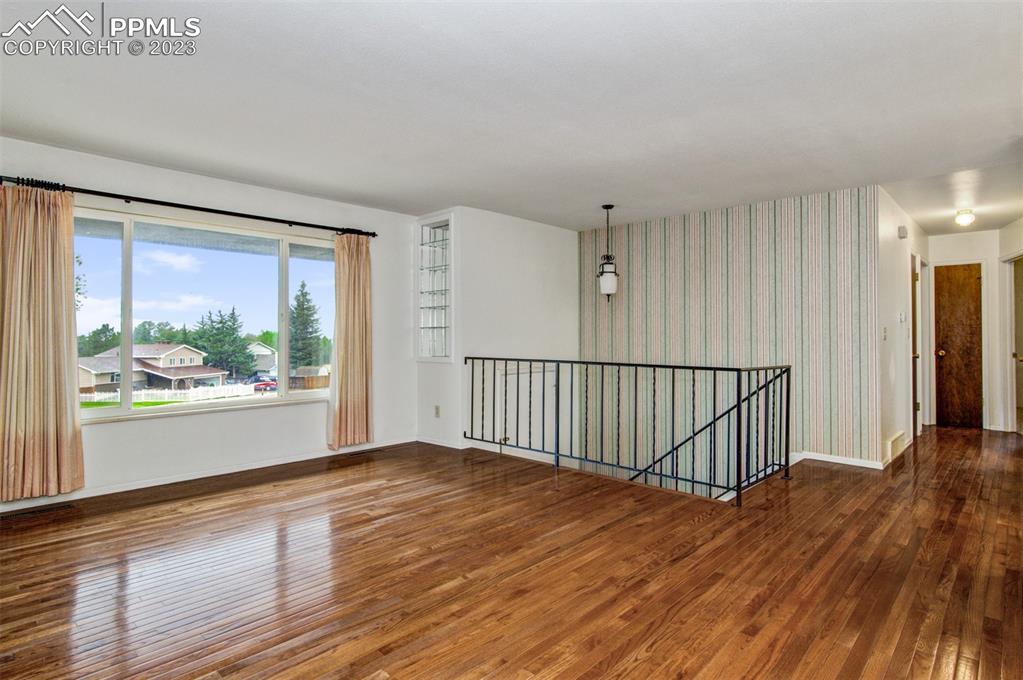 5380 Babcock Court Colorado Springs, CO 80915 - Photo 2 of 28 a view of an empty room with wooden floor and a window