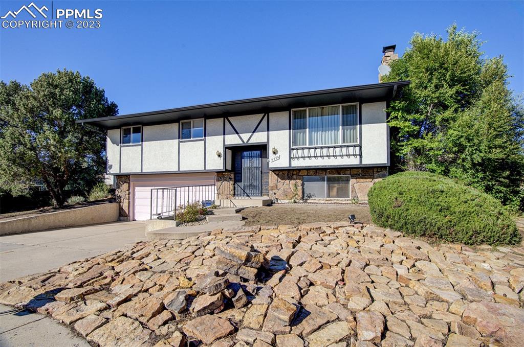 5380 Babcock Court Colorado Springs, CO 80915 - Photo 24 of 28 a front view of a house with a garden