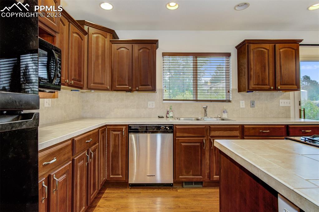 5380 Babcock Court Colorado Springs, CO 80915 - Photo 6 of 28 a kitchen with granite countertop a sink a stove and cabinets