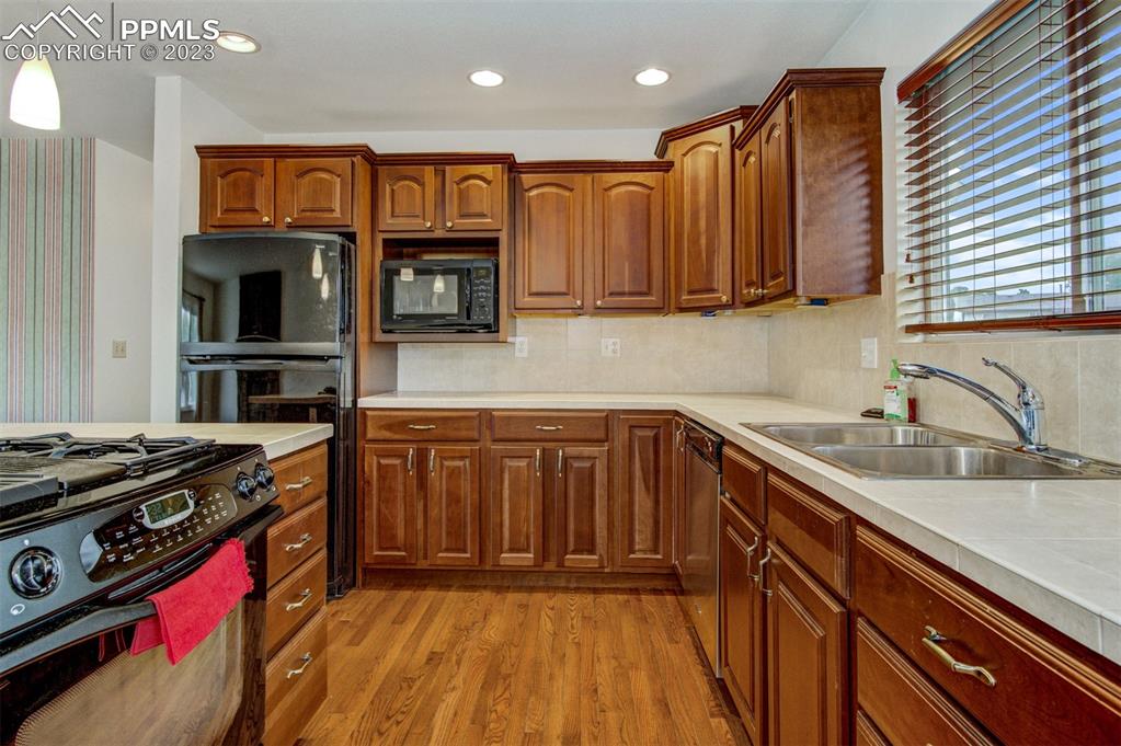 5380 Babcock Court Colorado Springs, CO 80915 - Photo 7 of 28 a kitchen with a sink stove top oven and cabinets