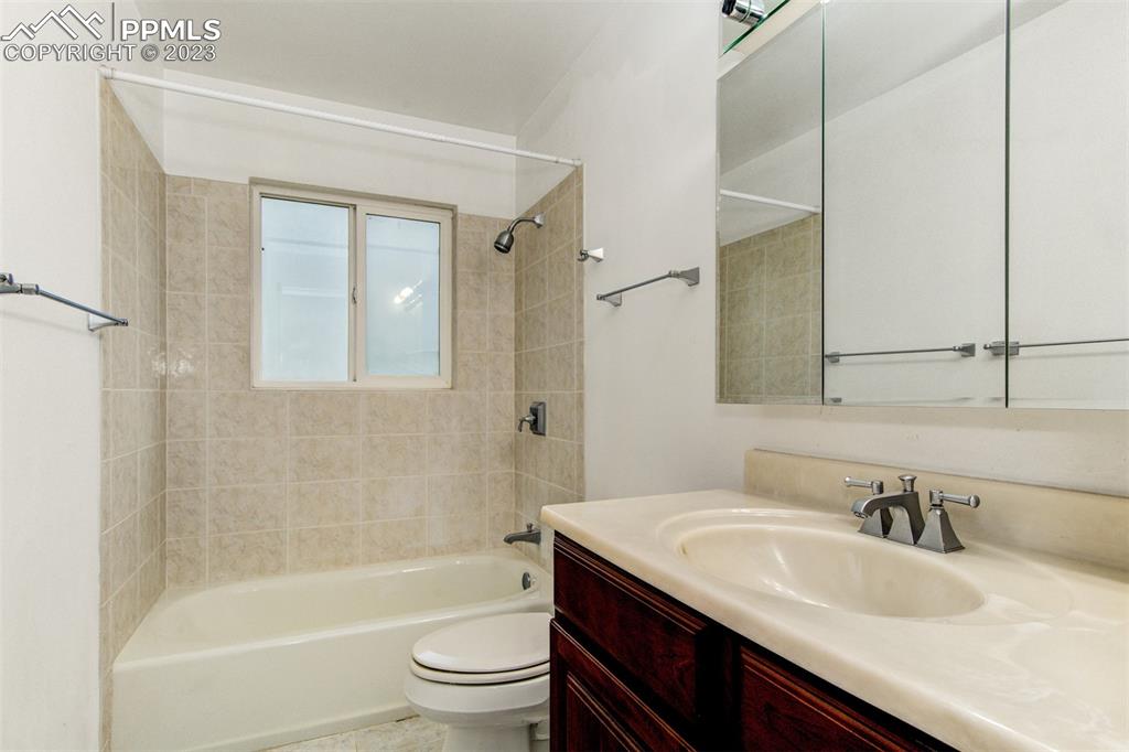 5380 Babcock Court Colorado Springs, CO 80915 - Photo 8 of 28 a bathroom with a granite countertop sink toilet and shower
