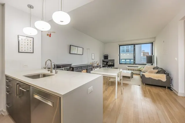 a kitchen with sink cabinets and chairs