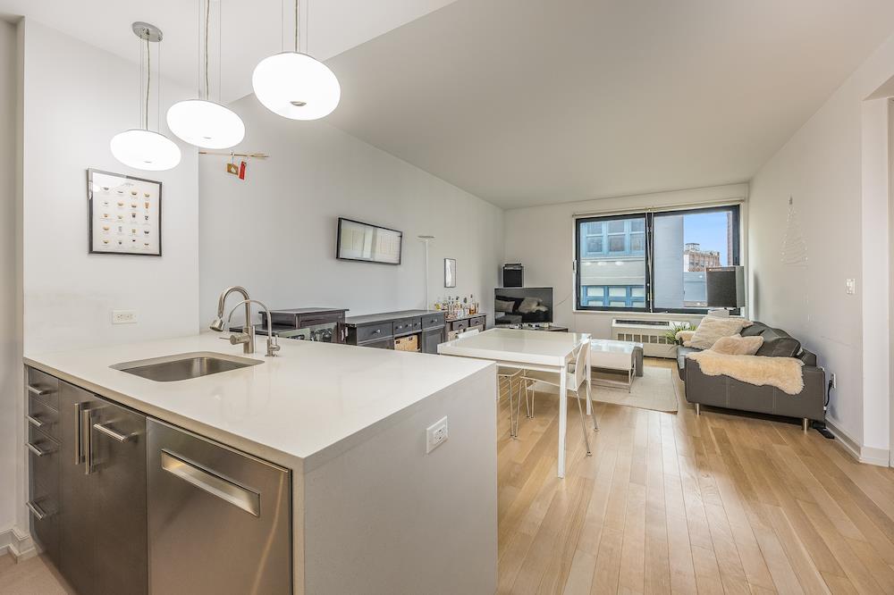 21-45 44th Drive, Unit 3I Queens, NY 11101 - Photo 4 of 20 a living room with furniture a dining table and chairs