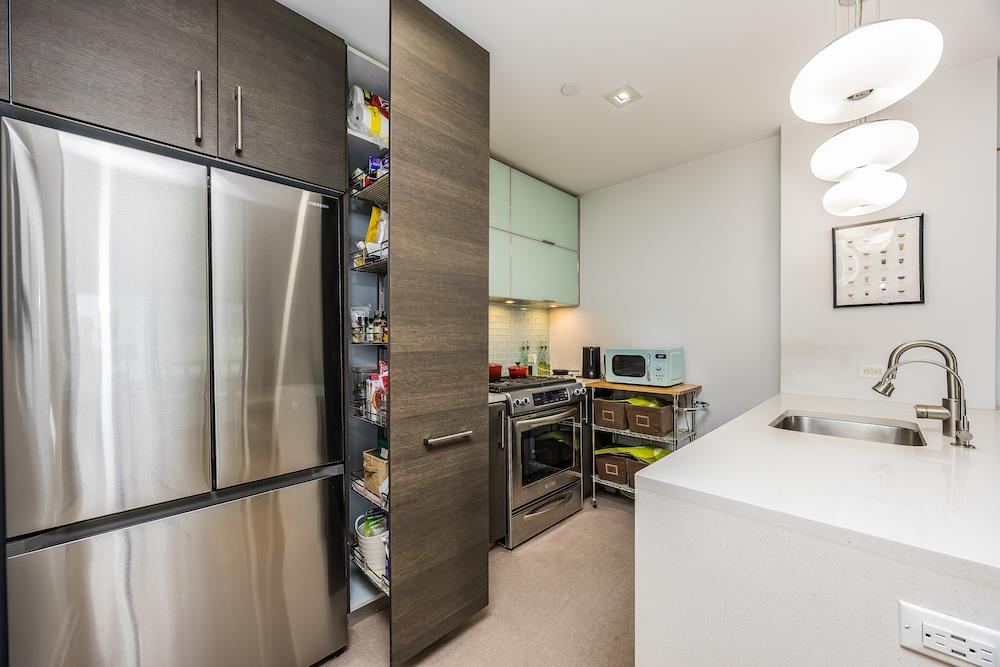 21-45 44th Drive, Unit 3I Queens, NY 11101 - Photo 5 of 20 a kitchen with refrigerator and window