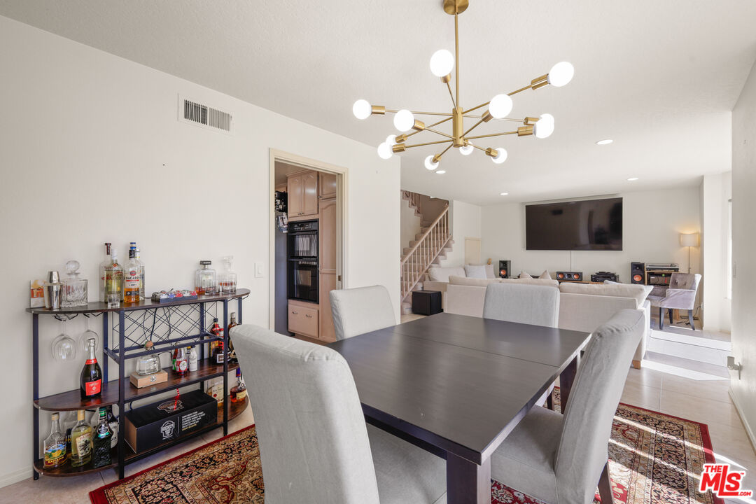 12119 Falcon Crest Way Porter Ranch, CA 91326 - Photo 13 of 51 a view of a dining room with furniture and a flat screen tv