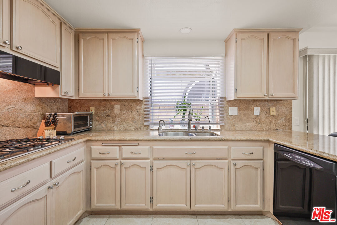 12119 Falcon Crest Way Porter Ranch, CA 91326 - Photo 16 of 51 a kitchen with white cabinets and sink