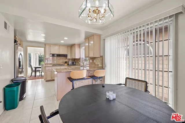 a living room with stainless steel appliances kitchen island granite countertop furniture and a kitchen view