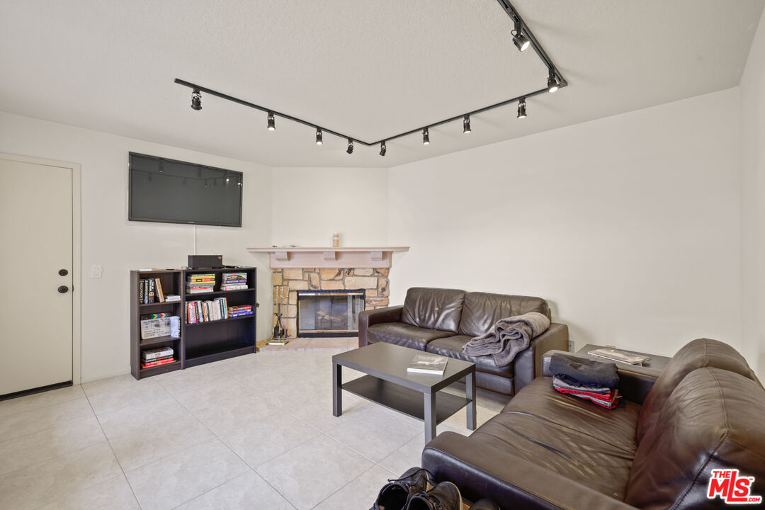 12119 Falcon Crest Way Porter Ranch, CA 91326 - Photo 20 of 51 a living room with furniture and a flat screen tv