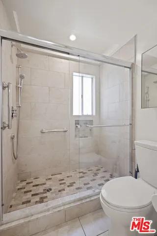 a bathroom with a shower and a toilet