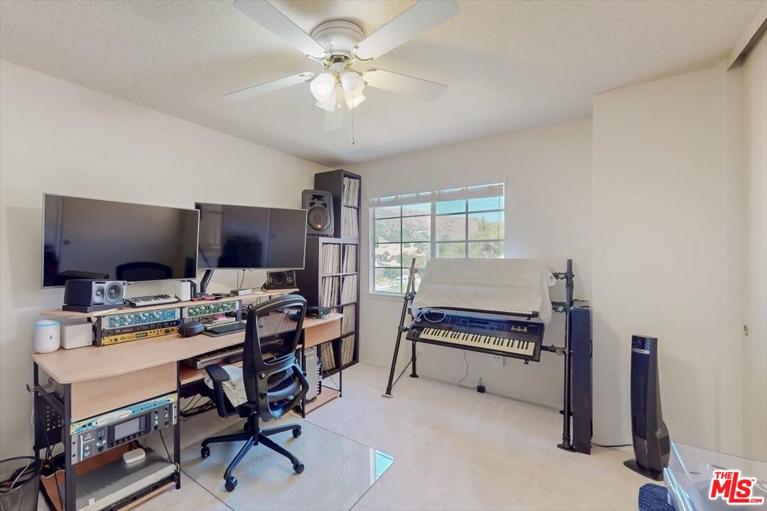 12119 Falcon Crest Way Porter Ranch, CA 91326 - Photo 27 of 51 a bedroom with furniture a chandelier and a window