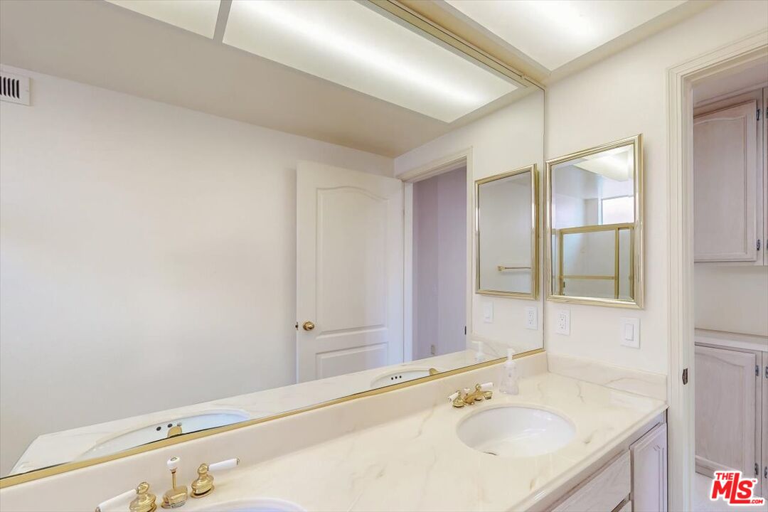 12119 Falcon Crest Way Porter Ranch, CA 91326 - Photo 32 of 51 a bathroom with a sink and a mirror