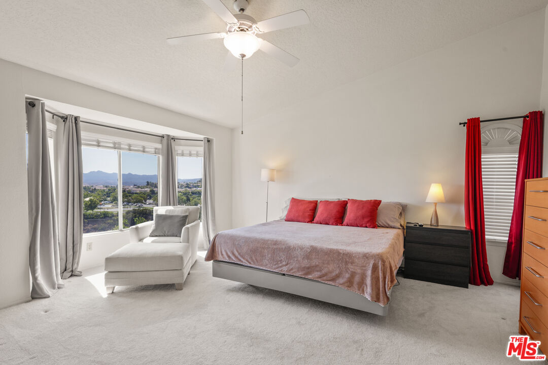 12119 Falcon Crest Way Porter Ranch, CA 91326 - Photo 33 of 51 a bedroom with a bed and a couch