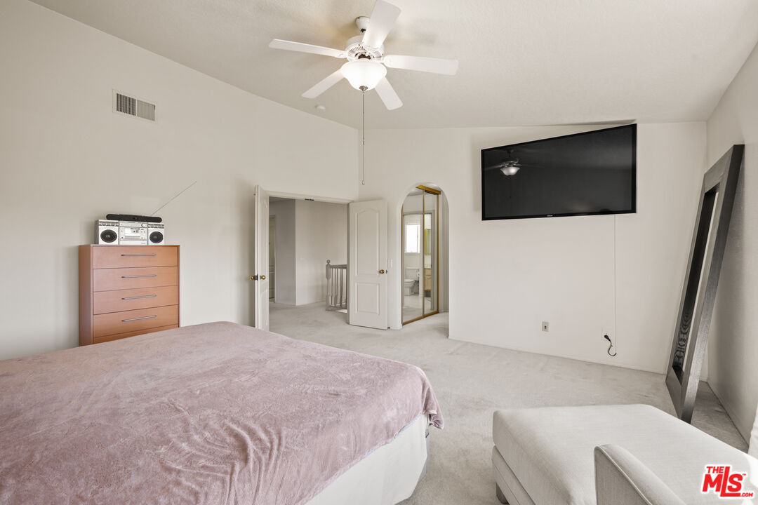 12119 Falcon Crest Way Porter Ranch, CA 91326 - Photo 35 of 51 a bedroom with a bed and a ceiling fan