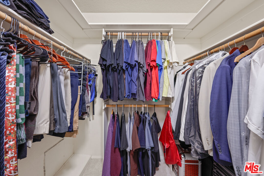 12119 Falcon Crest Way Porter Ranch, CA 91326 - Photo 37 of 51 a view of walk in closet with clothes