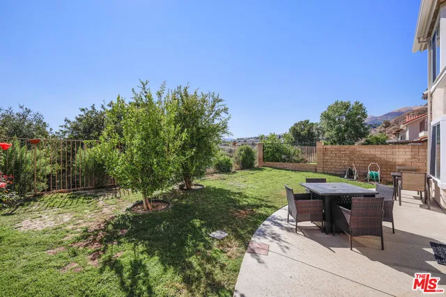 a view of a backyard with furniture