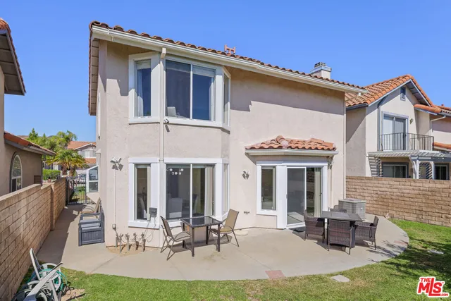 a view of a house with outdoor seating space
