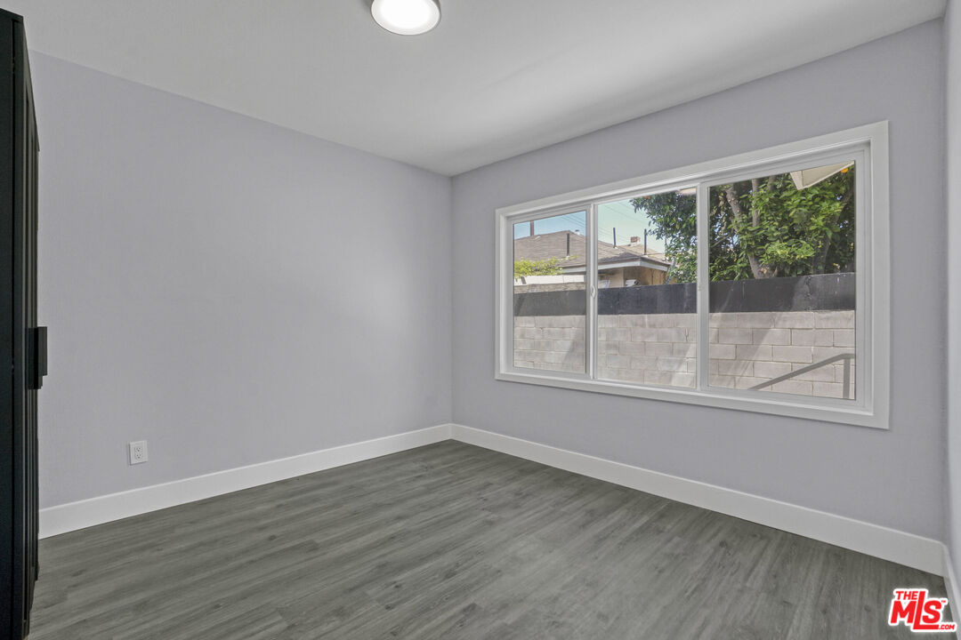 1256 Exposition Boulevard Los Angeles, CA 90007 - Photo 16 of 28 a view of empty room with wooden floor and fan