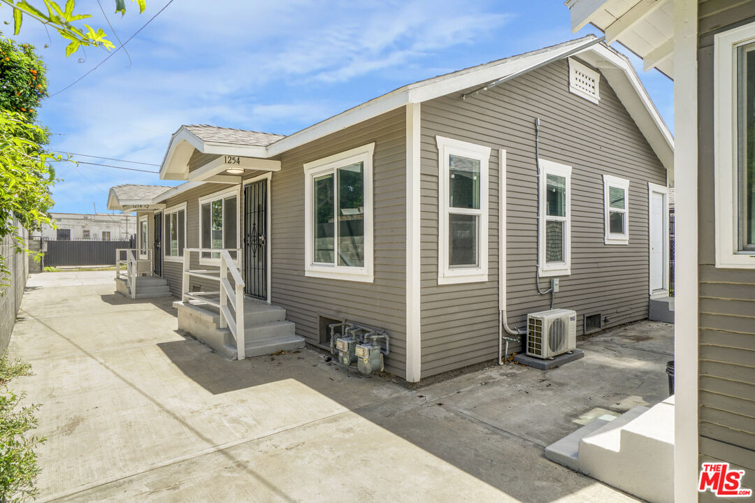 1256 Exposition Boulevard Los Angeles, CA 90007 - Photo 2 of 28 a front view of a house with a chair and glass door
