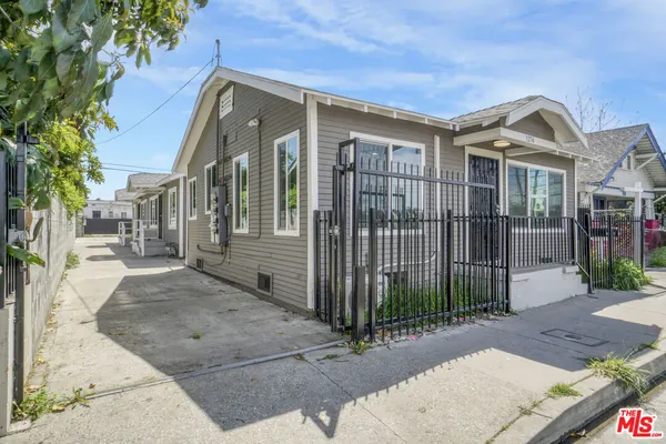 a view of a brick house that has large windows