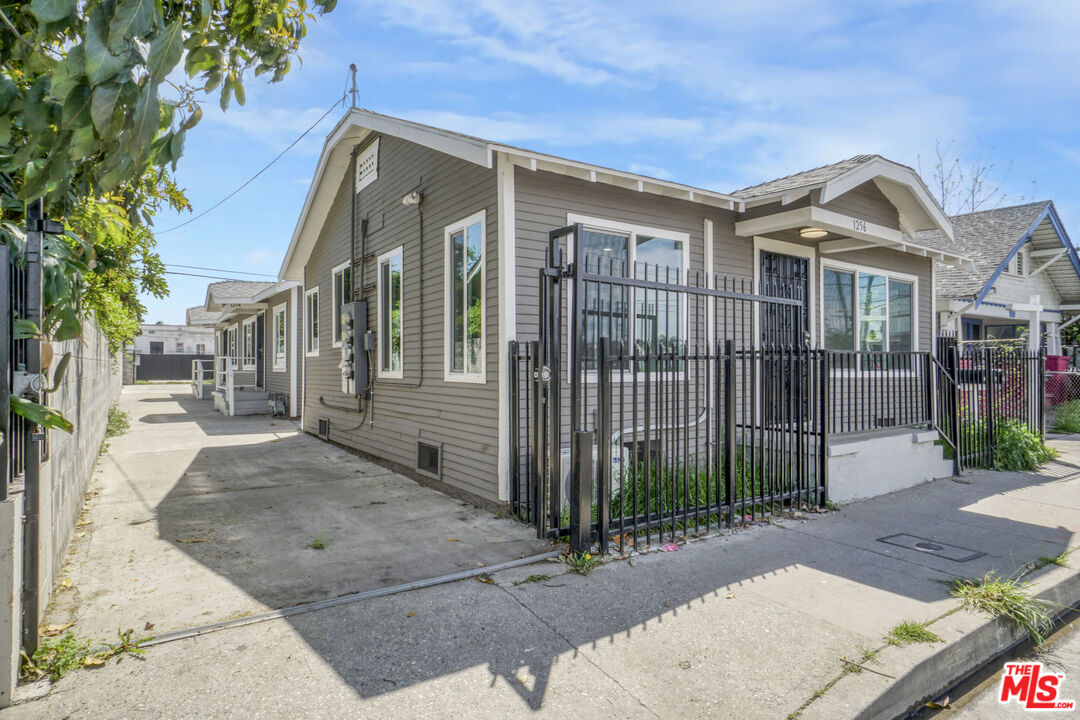 1256 Exposition Boulevard Los Angeles, CA 90007 - Photo 3 of 28 a view of a brick house that has large windows