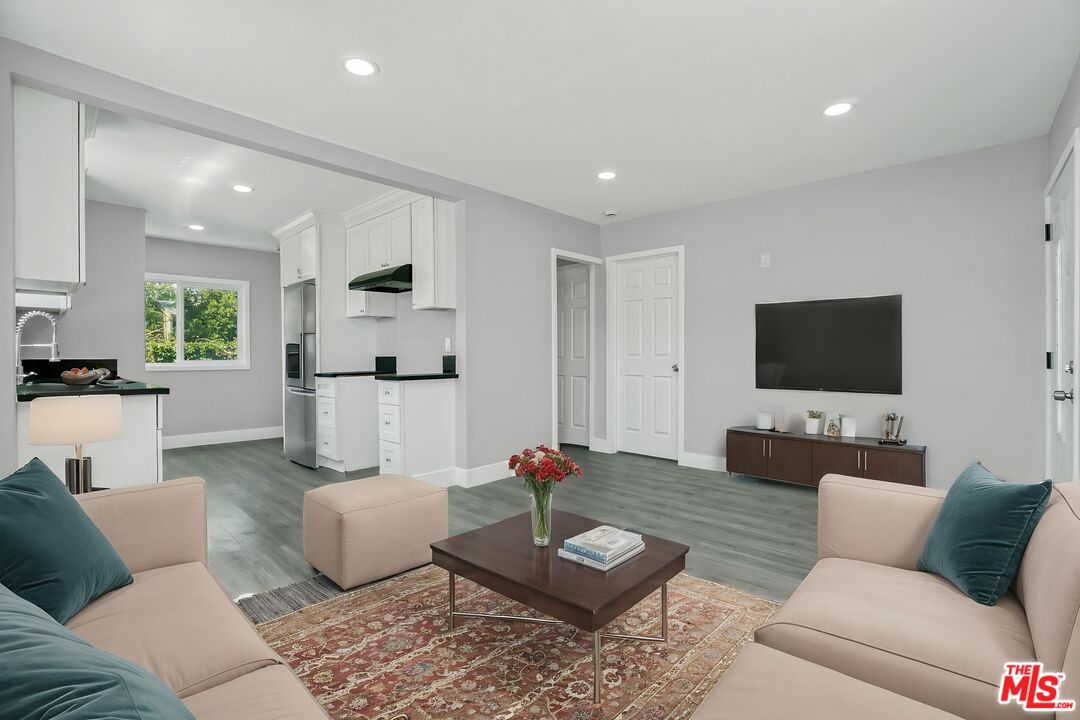 1256 Exposition Boulevard Los Angeles, CA 90007 - Photo 5 of 28 a living room with furniture and a flat screen tv