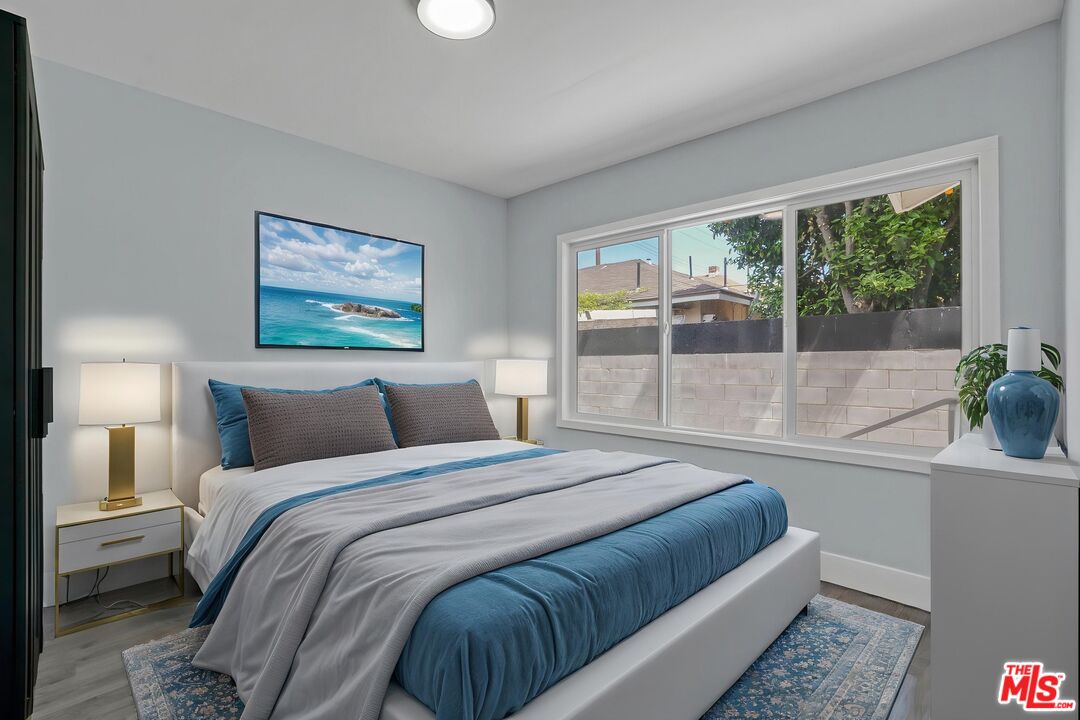 1256 Exposition Boulevard Los Angeles, CA 90007 - Photo 7 of 28 a bedroom with a bed and a large window