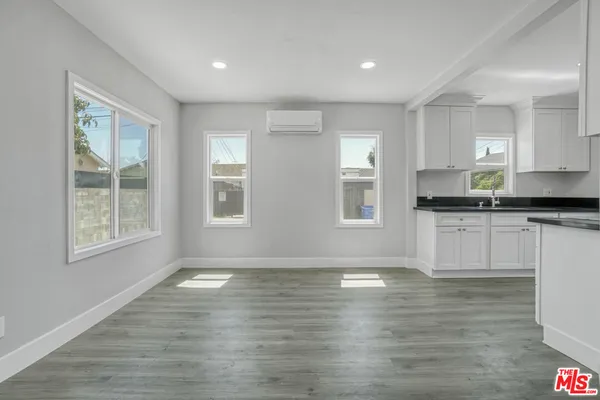a view of kitchen with granite countertop cabinets and wooden floor