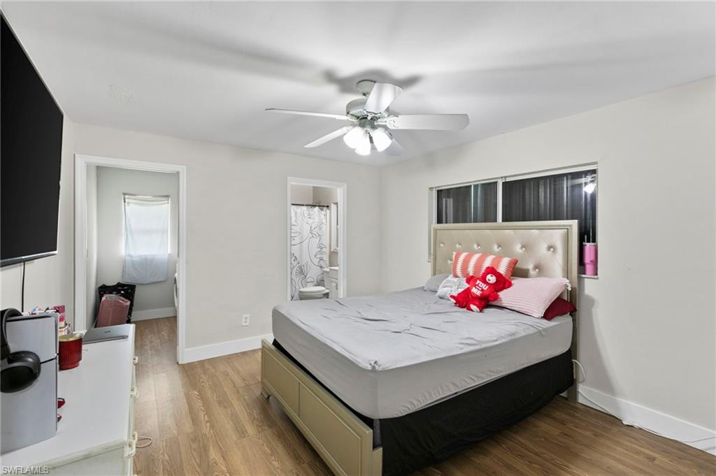 8264-8268 Matanzas Road Fort Myers, FL 33967 - Photo 22 of 33 a bedroom with a bed and a chandelier