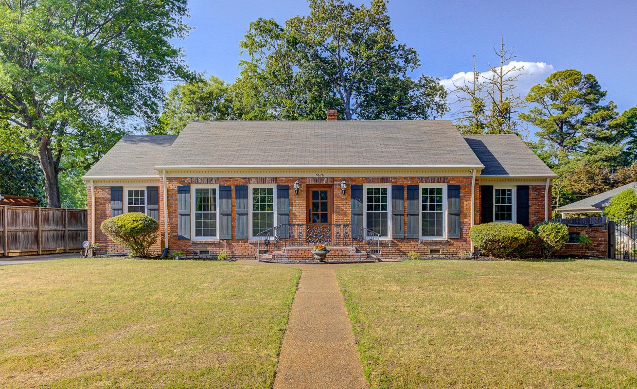 5676 Barfield Road Memphis, TN 38120 - Photo 18 of 19 Brick exterior with a gabled roofline, featuring dark shutters and white-framed windows