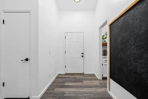 a view of a room with wooden floor and a fireplace
