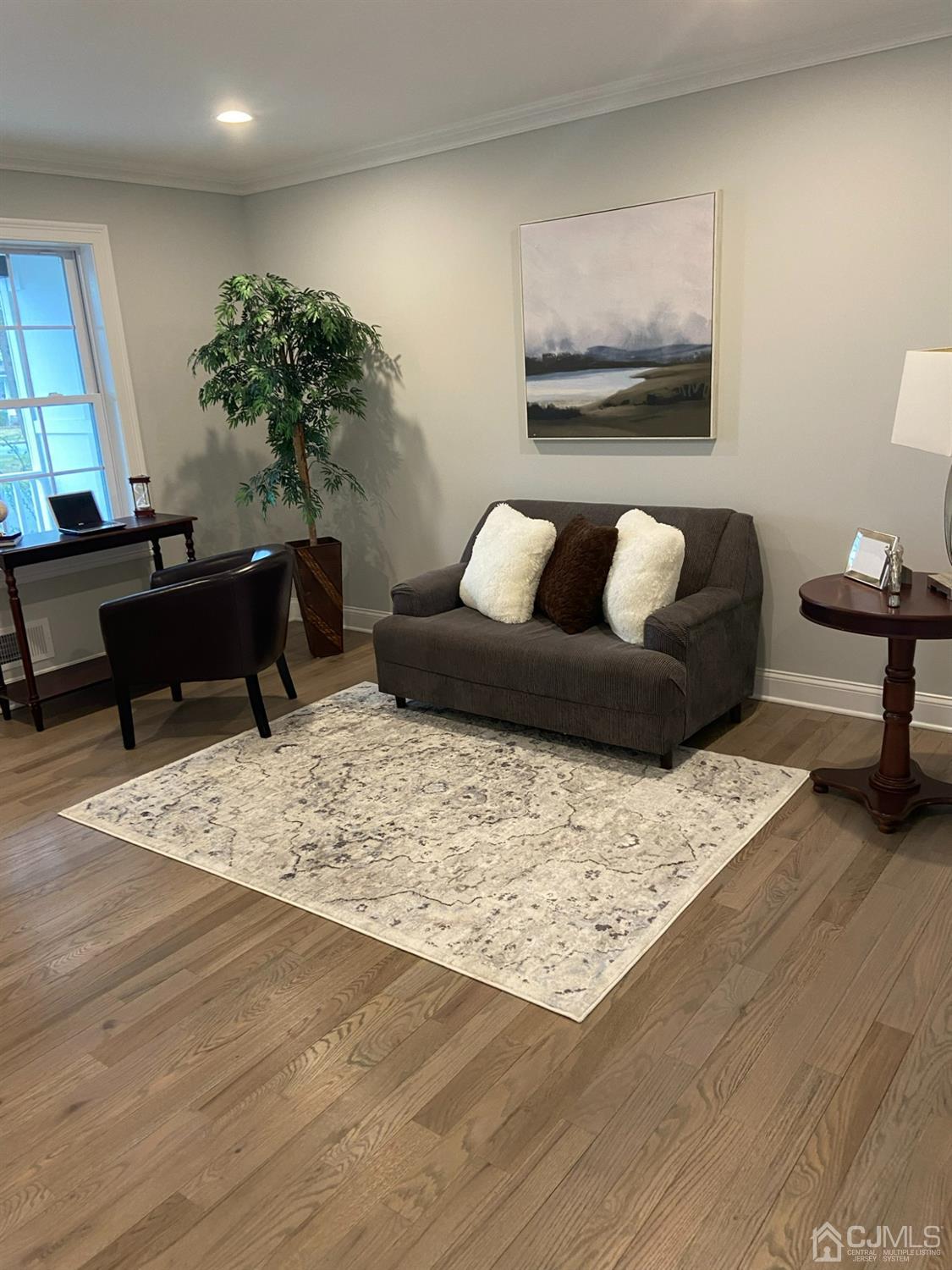 a living room with furniture and a wooden floor