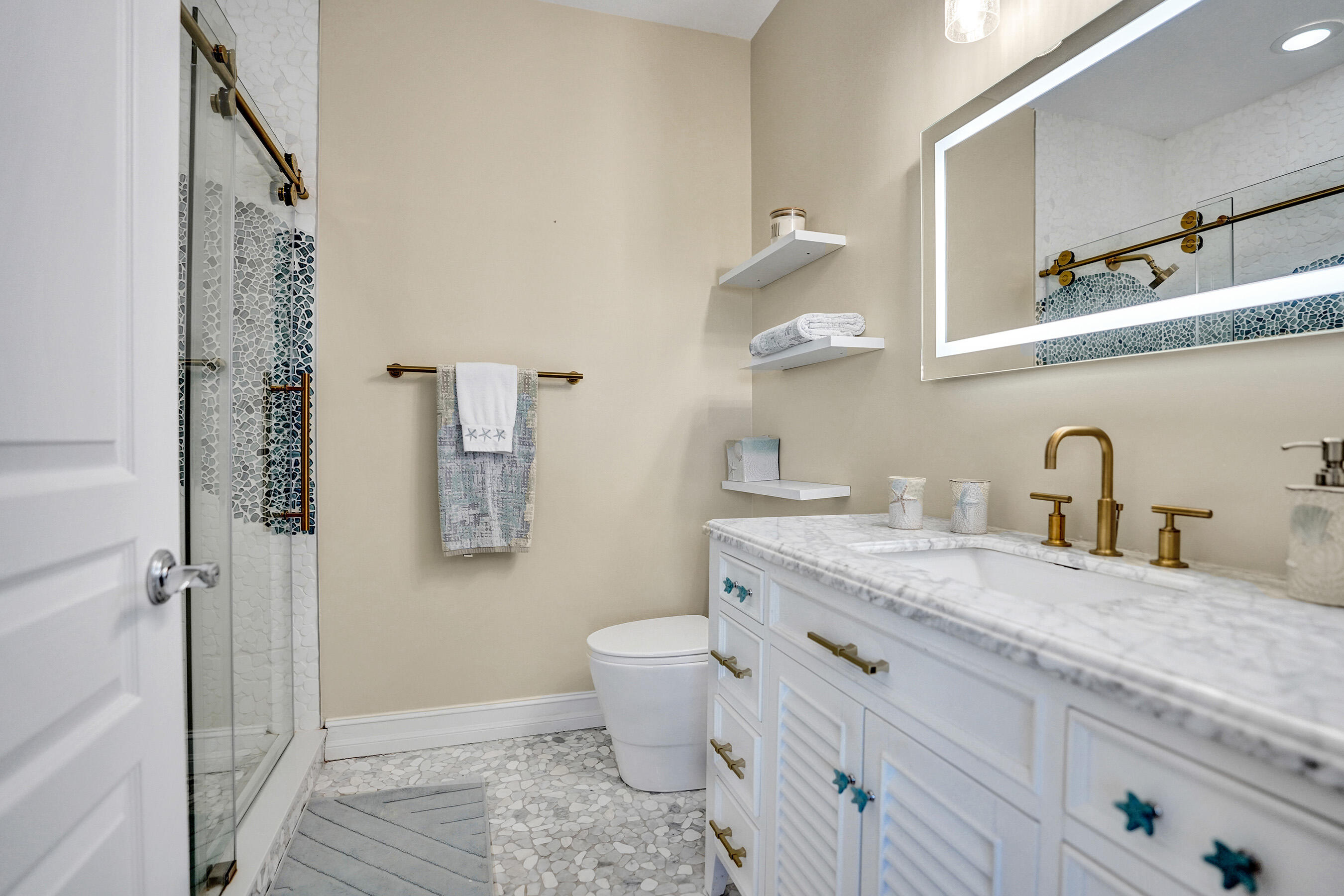 314 Northwest 1st Street Delray Beach, FL 33444 - Photo 17 of 26 a bathroom with a granite countertop toilet sink and mirror