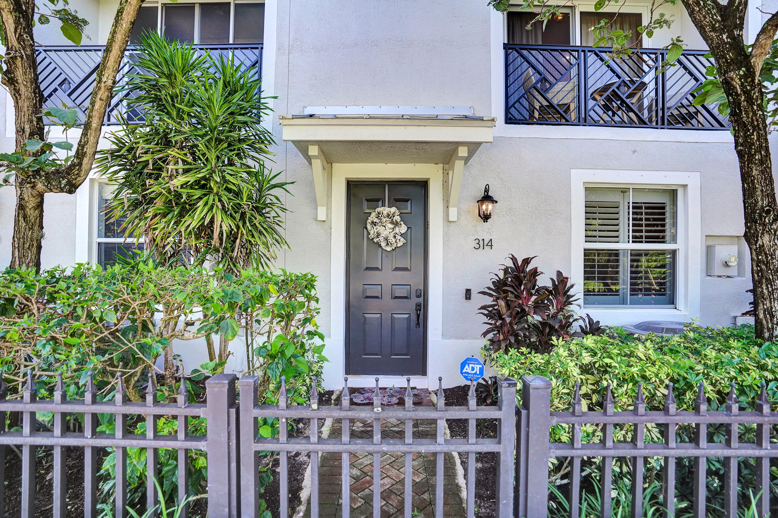314 Northwest 1st Street Delray Beach, FL 33444 - Photo 5 of 26 a front view of a house with a garden