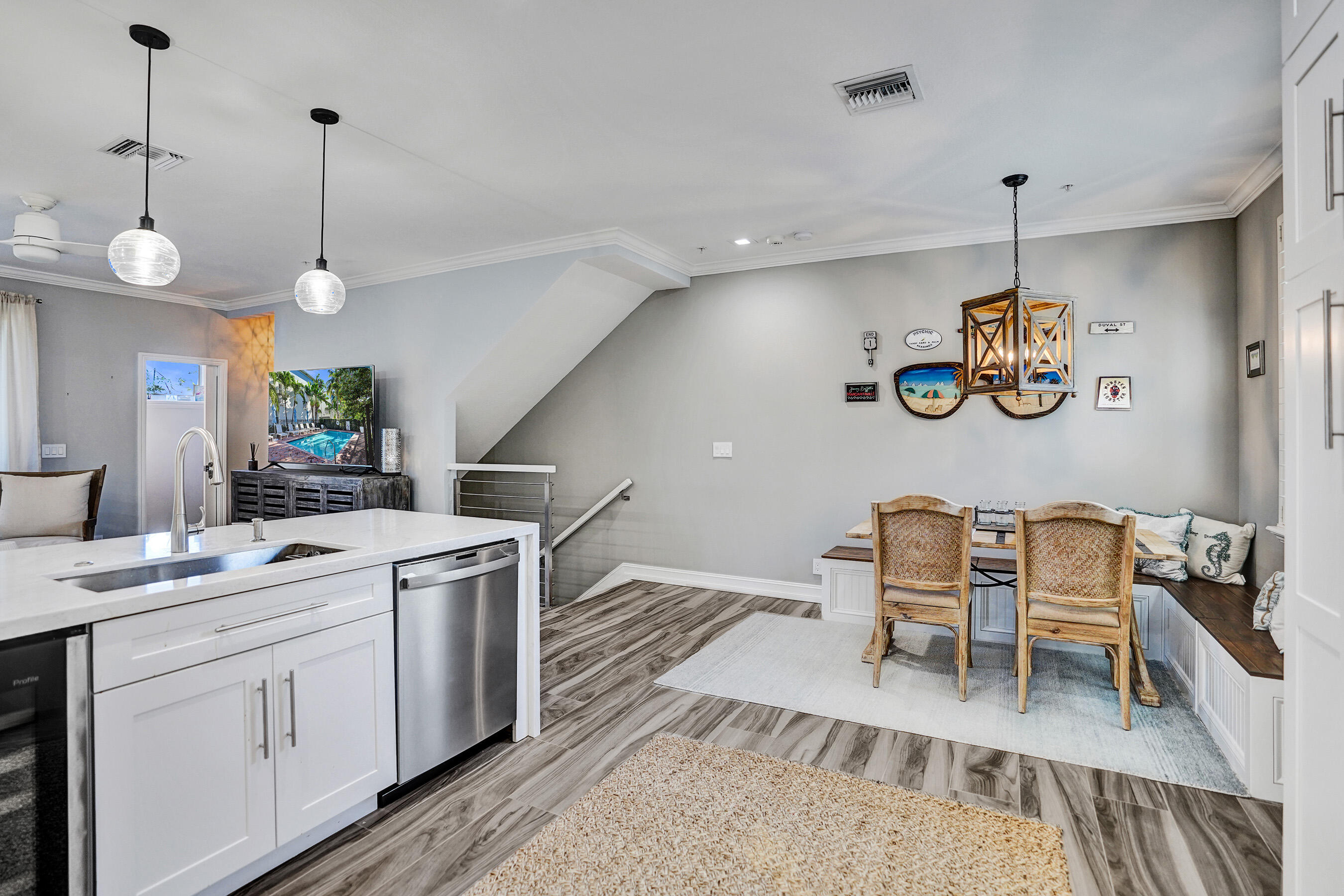 314 Northwest 1st Street Delray Beach, FL 33444 - Photo 9 of 26 a kitchen with a refrigerator a sink dishwasher a dining table and chairs with wooden floor