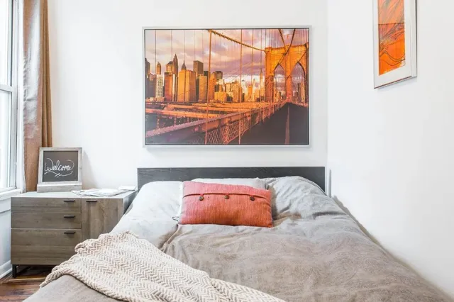 a bedroom with a bed and wall painting