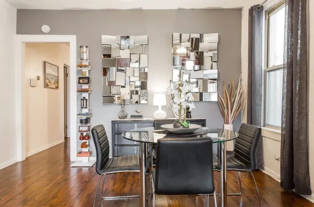 a view of a dining room with furniture and wooden floor