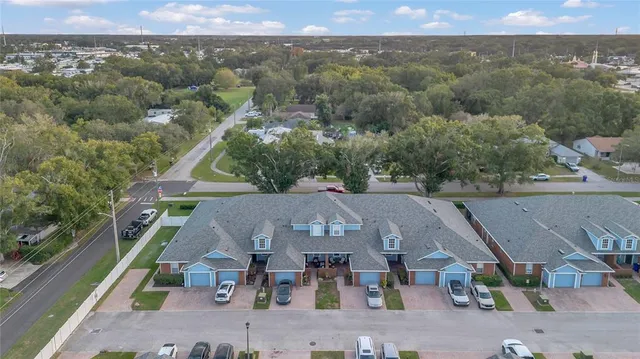 an aerial view of a house with a big yard