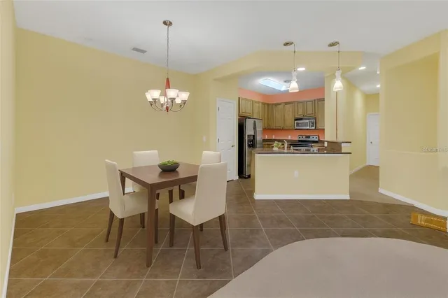 a kitchen with a table and chairs in it